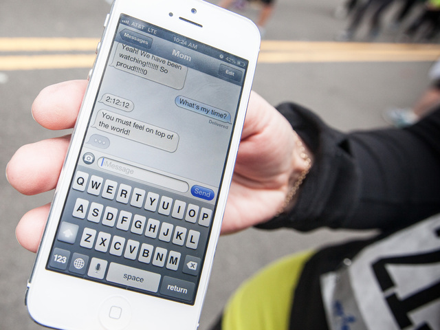 <p>Carey Piascik, 26, shows text messages from her Mom, one of which tells her that she finished the race in 2:12:12 at the South Street Seaport on Mar. 17th, 2013.</p>
