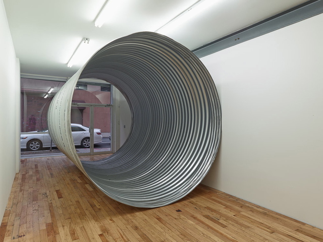 <p>A metal pipe is the only artwork in Charles Harlan's exhibition "Cave."</p>
