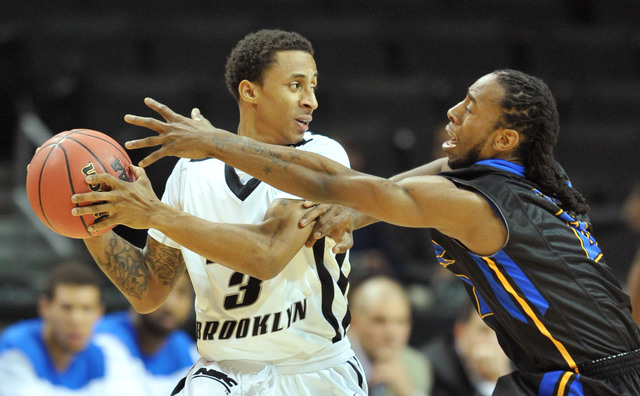 <p>C.J. Garner #3 of the LIU Brooklyn Blackbirds (L) looks to pass around Devon Atkinson #2 of the Morehead State Eagles during the Barclays Center Classic at the Barclays Center.</p>
