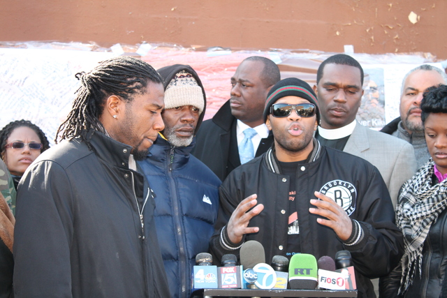 <p>Kimani Gray's father, Gerard Gray, dressed in the blue coat, made a brief appearance at the press conference.</p>
