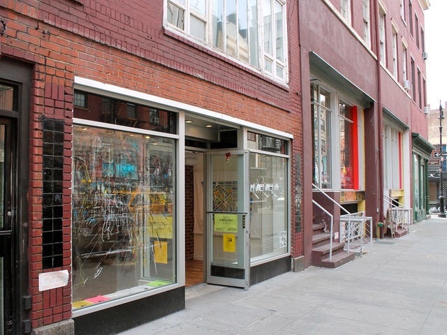<p>The storefront is located on the south side of West Eighth Street, west of MacDougal Street.</p>
