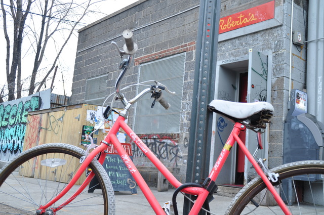 <p>A customer's bike was locked to a pole outside Roberta's Pizza Friday. The restaurant hopes to install four bike corrals on Moore Street this spring.</p>
