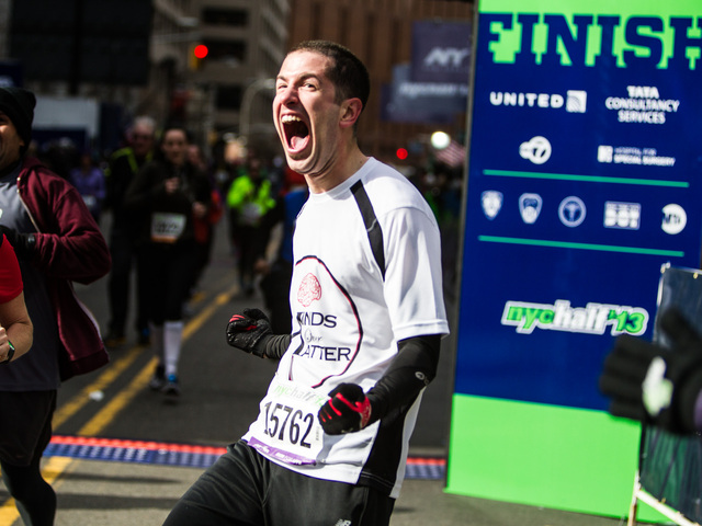 <p>A runner celebrates after crossing the finish line of the 8th Annual NYC Half marathon at the South Street Seaport Mar. 17th, 2013.</p>
