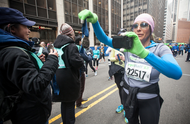 <p>A runner receives her medal after completing the annual NYC Half marathonn at the South Street Seaport on Mar. 17, 2013.</p>
