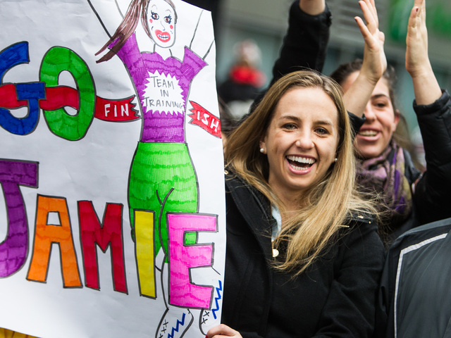 <p>A spectator cheers on her pal at the finishing line of the 8th annual NYC Half marathon at the South Street Seaport in Lower Manhattan on Mar. 17th, 2013.</p>
