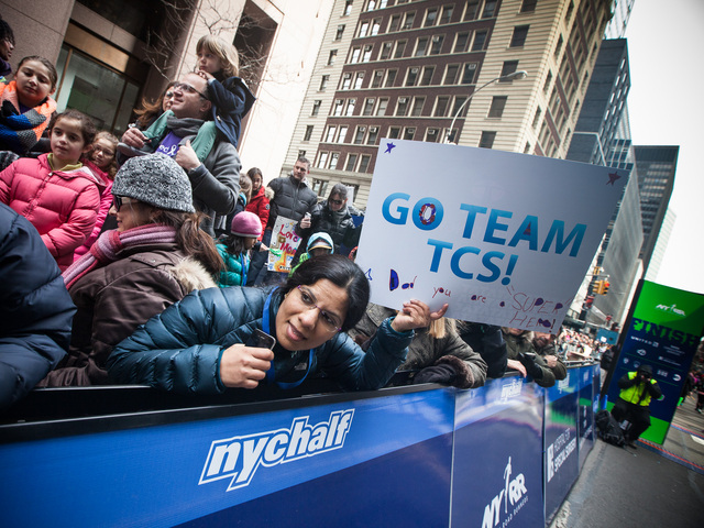 <p>A spectator looks for her pal at the finish line of the NYC Half marathon at the South Street Seaport on Mar. 17, 2013.</p>
