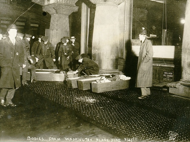 <p>A March 25, 1911, photo shows officials placing Triangle Shirtwaist Company fire victims into caskets.&nbsp;</p>
