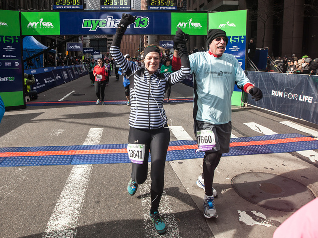 <p>Two runners cross the finish line of the 8th Annual NYC Half marathon at the South Street Seaport on Mr. 17, 2013.</p>
