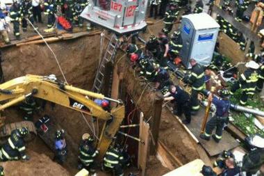  Firefighters work to rescue a worker who got stuck in the mud after a 25-foot deep trench collapse at 119-02 83rd Avenue in Kew Gardens, Queens, Tuesday afternoon, June 18, 2013. 
