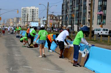 Volunteers and artists gathered over the weekend to paint on the plain jersey barriers.