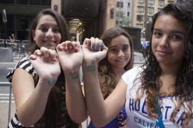 Fans lined West 54th Street outside the Ziegfeld Theatre to catch a glimpse of the pop band One Direction on Monday. The band was scheduled to appear for the New York debut of its concert documentary, "This is Us."