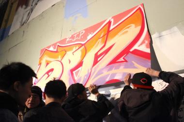 A crowd gathered at the Long Island City site to mourn the art that was painted over Tuesday morning.