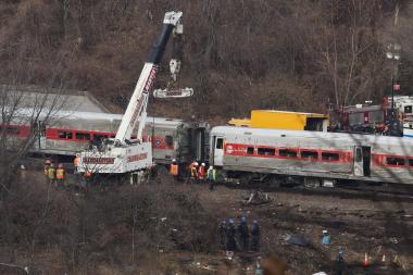 Investigators pored over a derailed Metro-North train in The Bronx.