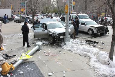 A stolen car crashed into two light poles and another car at Buschwick Avenue and Siegel Street on Wednesday.