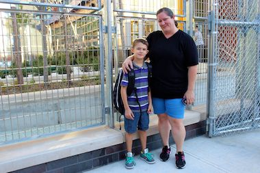 Victoria Voss and her son Anthony head to the first day of school at P.S. 78 in Long Island City. Voss said the new hours at the school — where classes start 40 minutes earlier than last year — work better for her schedule.