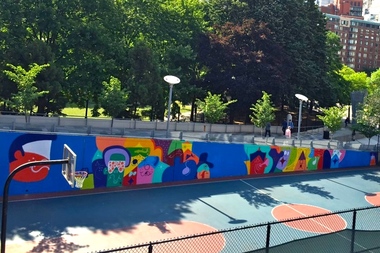 A long, colorful mural by Todd James now covers a wall at Washington Market Park basketball courts.