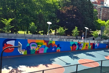  A long, colorful mural by Todd James now covers a wall at Washington Market Park basketball courts. 