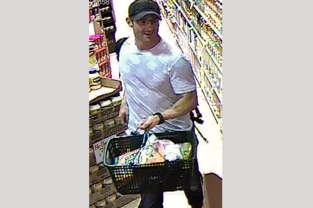  Police released a surveillance photo of a suspect shopping at KeyFood after he stole a wallet from the men’s locker at a Kew Gardens gym. 