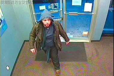 Police have released an additional image of a bank robber who passed a note to a Rego Park bank teller last month demanding money and stole $2,600.