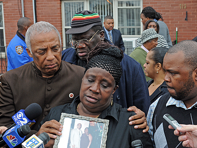 <p>June Facey, wife of 52-year-old Raymond, who was shot on Tuesday, Oct. 23, 2012, clutches a photo of her and her husband.</p>
