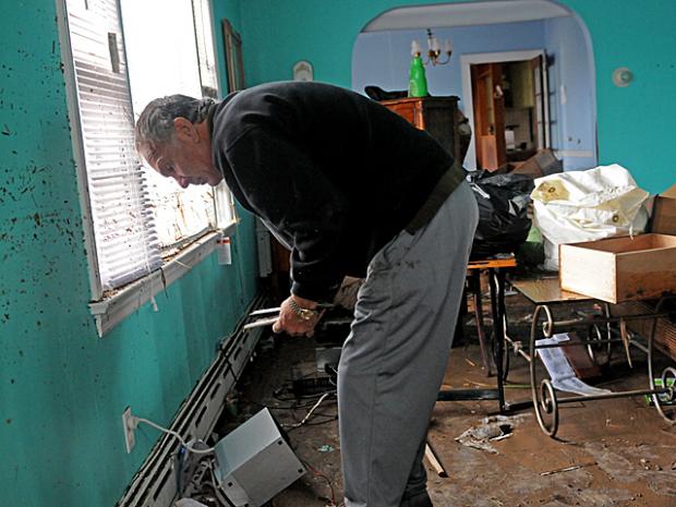 <p>Don Hallihan, 55, cleaned out his Staten Island home on Fox Beach Avenue after it was flooded during Hurricane Sandy on Oct. 31, 2012.</p>