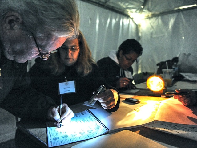 <p>Because of Hurricane Sandy-prompted power outages, volunteers on Staten Island had to work in the dark and cold on Election Day on Nov. 6, 2012.</p>
