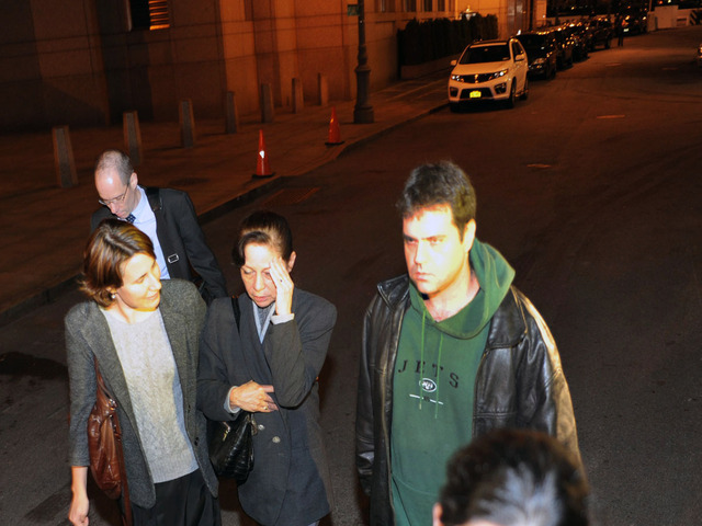 <p>Elizabeth Valle, mother of NYPD cop Gilberto Valle, with two other sons, left Gilberto Valle's arraignment Oct. 25, 2012.</p>
