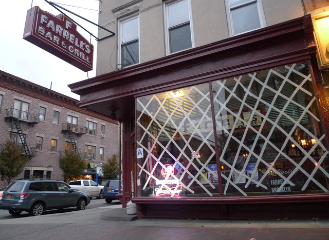 <p>Farrell's Bar in Windsor Terrace tapes up windows as patrons drink on, on October 28, 2012.</p>
