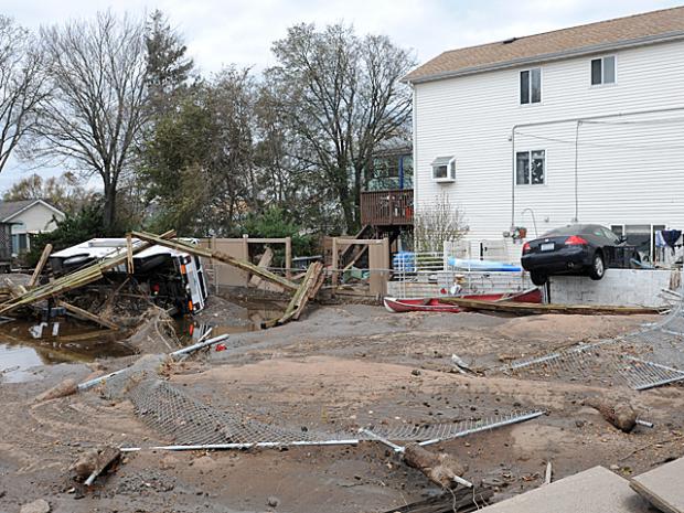 <p>A car and truck washed off into a lot on Father Capodanno Boulevard after Hurricane Sandy, Oct. 31, 2012.</p>