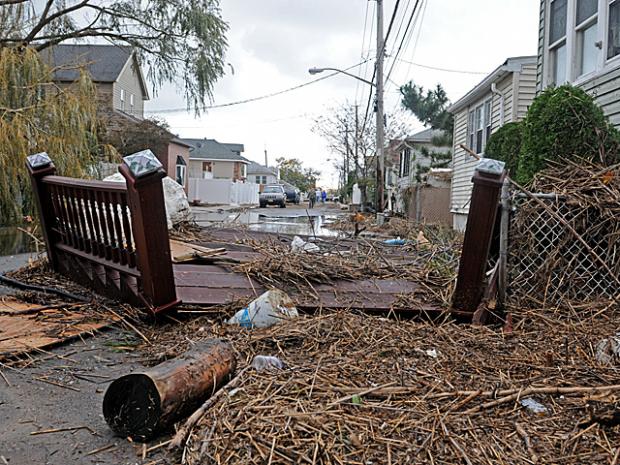 <p>Parts of homes littered Fox Beach Avenue, Staten Island, a day after Hurricane Sandy, Oct. 31, 2012.</p>