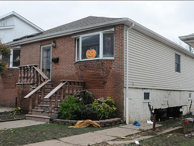 <p>John Filpowizz Sr., 51, and his son John Filpowizz Jr., 20, were discovered by police and National Guard soldiers trapped beneath debris in the basement of their home at 72 Fox Beach Ave., Staten Island, Oct. 31, 2012.</p>