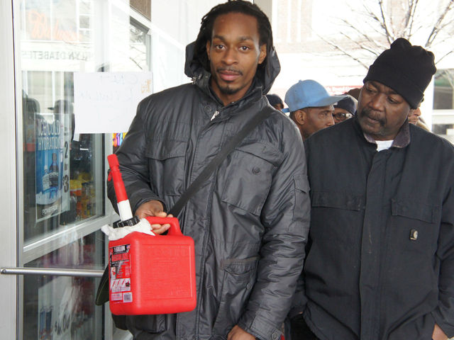 <p>A man waits with a gas can at a BP in Crown Heights.</p>
