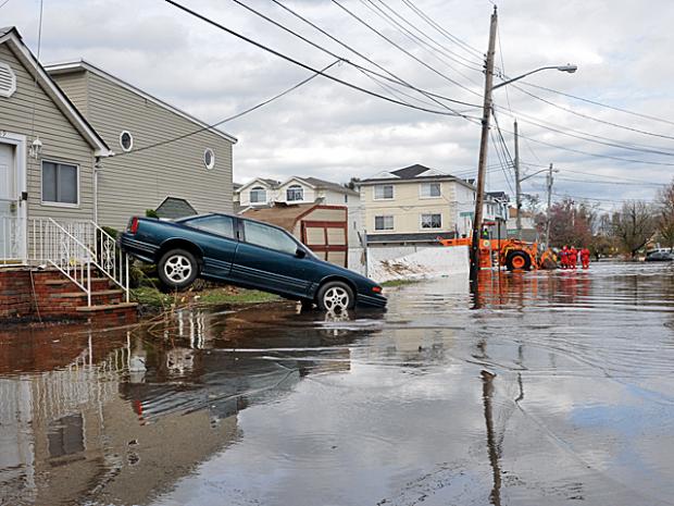 <p>A car washed into the front lawn on Grimsby Avenue, Staten Island. Two elderly women were found dead in their homes after Hurricane Sandy, Oct. 31, 2012.</p>