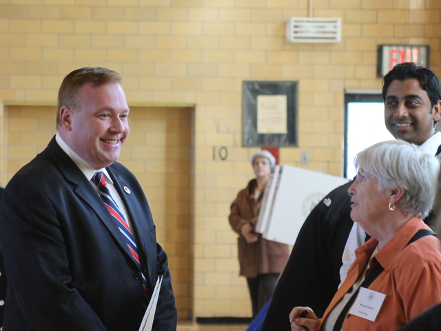 <p>City Councilman Dan Halloran chats with a poll worker at P.S. 184 in Whitestone on Nov. 6.</p>
