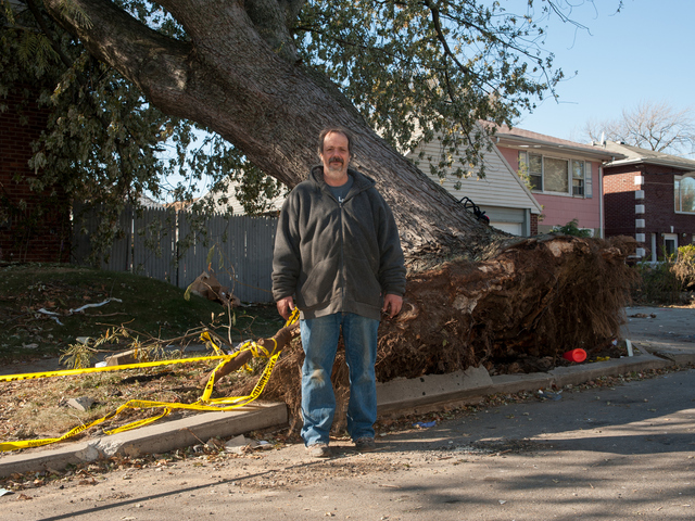 <p>John Greenholtz stands next to the tree that fell on his house during Hurricane Sandy on Tuesday November 06th, 2012.</p>
