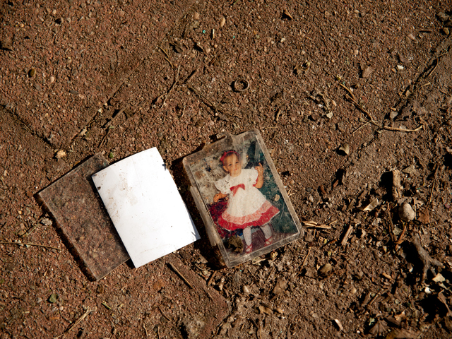 <p>An early photo of Janelle Greenholtz, daughter of John Greenholtz, lies amidst other damaged items on Tuesday November 06th, 2012.</p>
