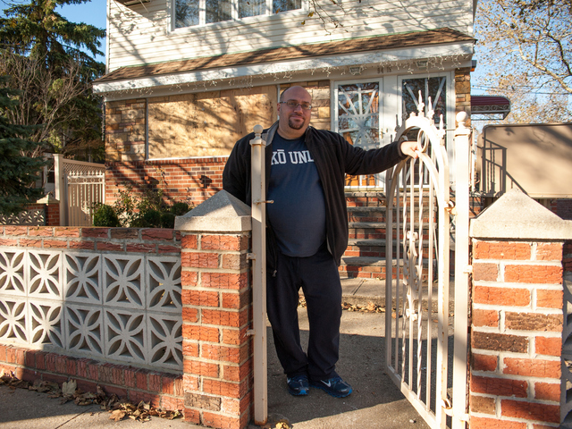 <p>Eddie Dibari stands in front of his damaged residence at the corner of 157th Avenue and 95th Street on Tuesday November 06th, 2012.</p>

