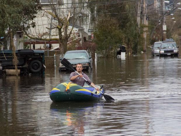 <p>A man rows to his home on Hunter Avenue in Midland Beach after Hurricane Sandy hit, Oct. 31, 2012.</p>