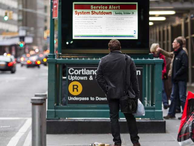 <p>A man checked the latest MTA travel updates near the World Trade Center as New York prepared for Hurricane Sandy Oct. 28, 2012.</p>
