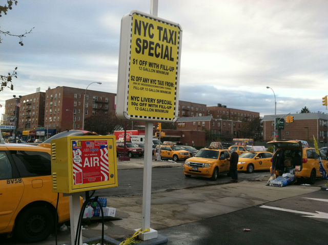 <p>A sign advertises a "NYC Taxi Special" at a Jackson Heights Shell station. The companies listed on the sign all belong to Evgeny Freidman.</p>
