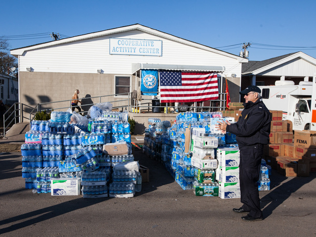 <p>A local resident heads towards the Rockaway Point Fire Station for supplies on Nov. 5th, 2012.</p>
