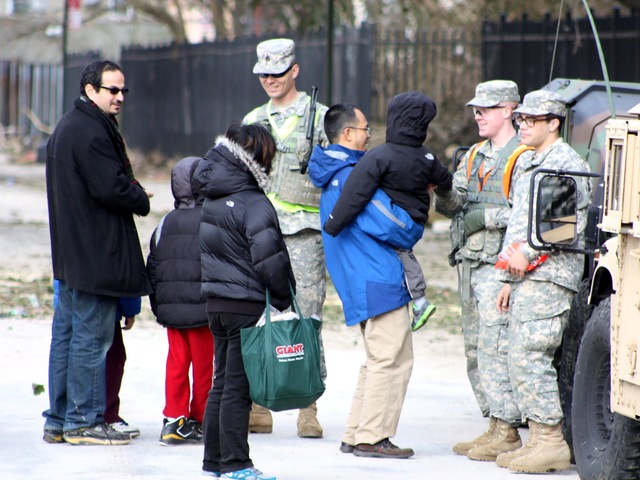 <p>Members of the National Guard talking to Coney Island residents.</p>
