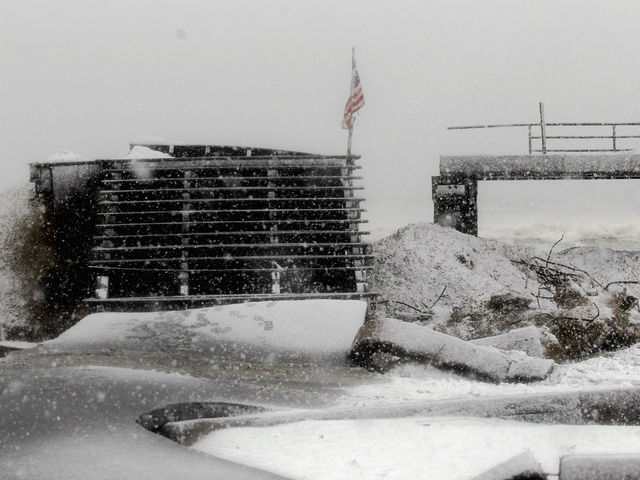 <p>Snow falls on a destroyed section of boardwalk as a Nor&rsquo;Easter approaches in the Rockaway neighborhood on November 7, 2012 in the Queens borough of New York City. The Rockaway Peninsula was especially hard hit by Superstorm Sandy and some are evacuating ahead of the coming storm.</p>

