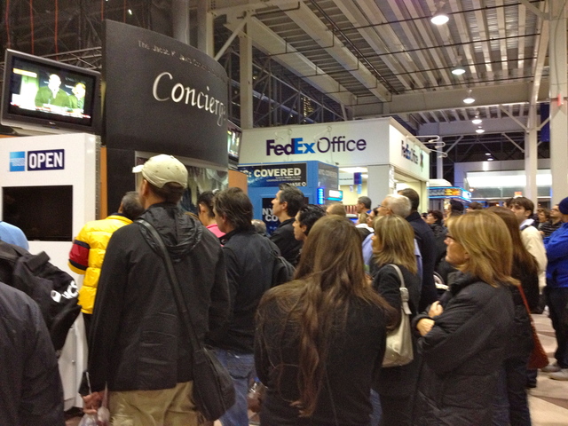<p>Runners gathered at the Marathon Expo watch as officials announce the cancelation of the NYC marathon on November 2, 2012.</p>
