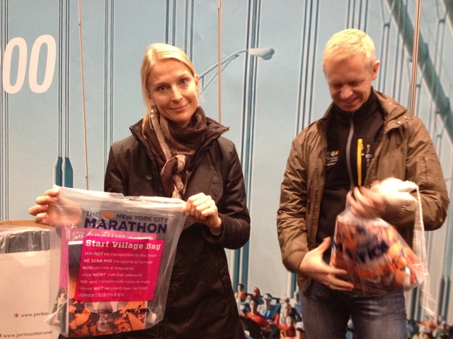 <p>Malin Brostrom, 37, from Sweden, holds her runner's packet at the Marathon Expo on November 2, 2012. She said her trip to NYC for the Marathon cost more than $3,000</p>
