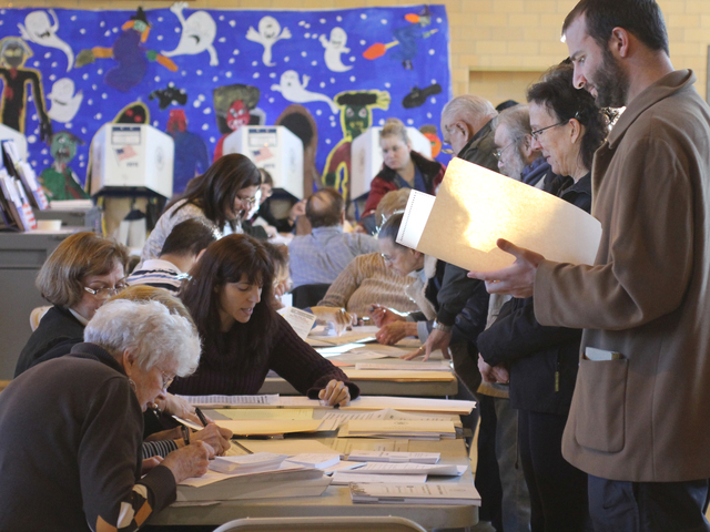 <p>Poll workers at help direct a voter at P.S. 184 in Whitestone on Nov. 6.</p>
