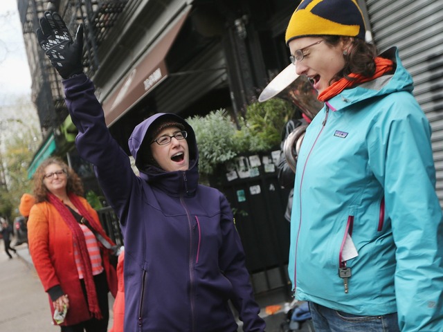 <p>HanaKyle Moran yells out 'Power!' while listening to a band play on the street shortly after power was restored in the East Village on November 2, 2012.&nbsp;</p>

