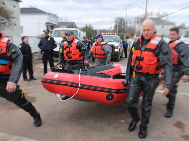 <p>October 31, 2012 - The NYPD use a plastic raft to look for anyone trapped in their home on Arthur Avenue.</p>