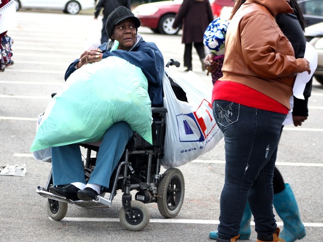 <p>A wheelchair-bound woman in Coney Island getting relief in the aftermath of Hurricane Sandy.</p>
