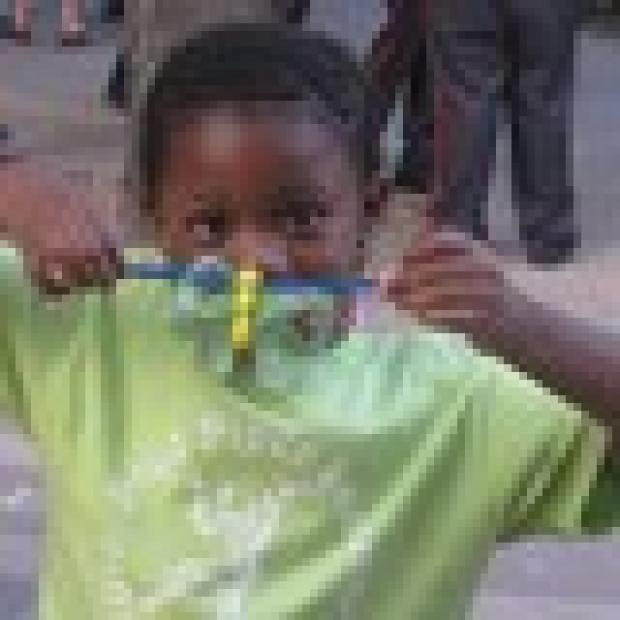 Aniyah, 6, is proud to show off what she made at the Arts & Crafts table.